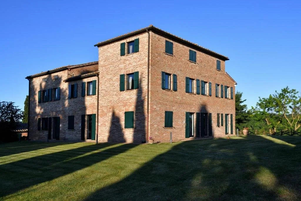 The brick country house under a clear blue sky