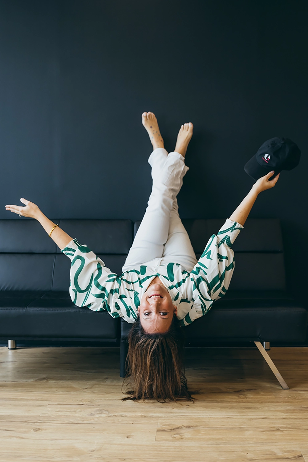 Kendra Beavis upside down on a couch